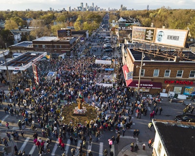 A crowd gathers at George Floyd Square in April 2021 after police officer Derek Chauvin was found guilty of murdering Floyd.