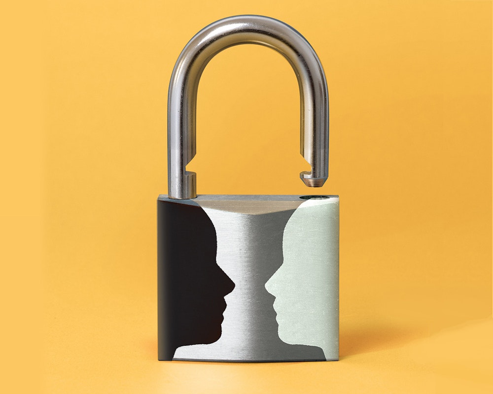Lead image of open lock with black and white face silhouettes on lock face facing each other.