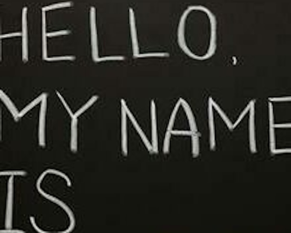 "Hello, my name is ____" written with chalk on a blackboard