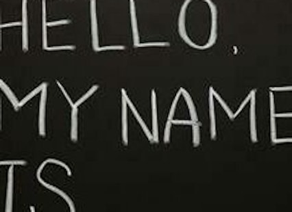 "Hello, my name is ____" written with chalk on a blackboard