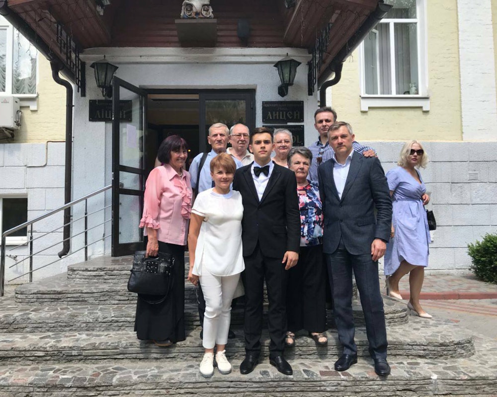 Danylo Yakymov (center) with his family in Kyiv on his high school graduation day.